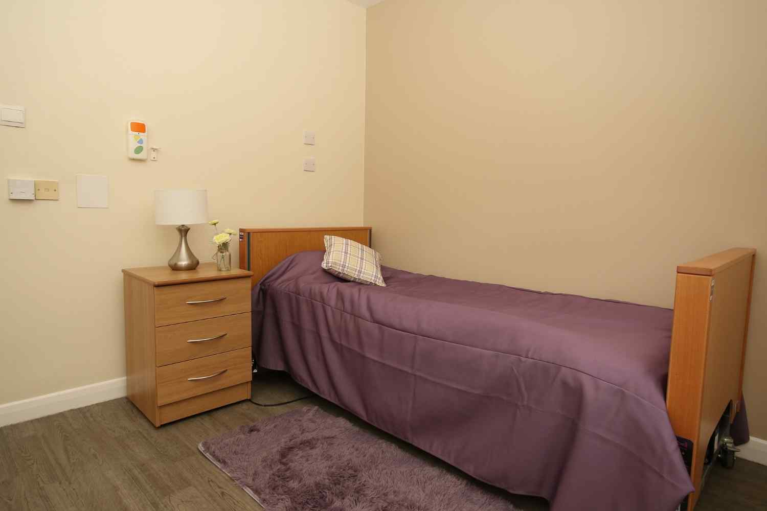 bed with purple duvet on